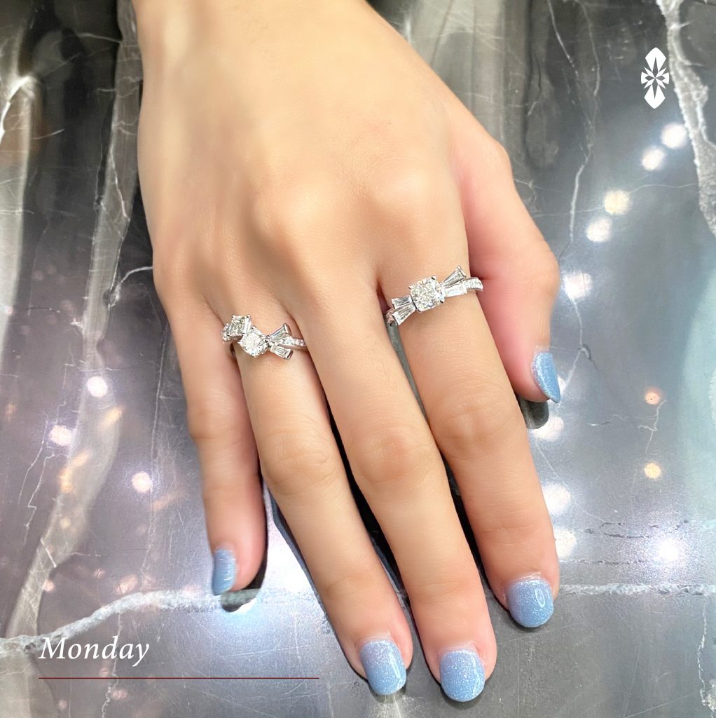 Diamonds wedding engagement rings on female finger with blue nails manicure  and fabric texture background. Beauty and fashion concept Stock Photo -  Alamy
